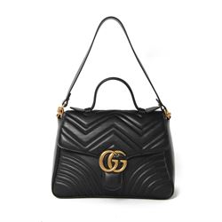 Gucci GG Marmont black matelassé leather top handle bag, made in Italy, with chevron quilted leather and heart motif to the reverse, antique gold-tone Double G front hardware, leather top handle and detachable chain shoulder strap with leather shoulder guard, front flap closure, suede-effect interior with zip pocket and leather logo tab stamped Gucci made in Italy, together with original Gucci dust bag and carrier, W27cm D11cm H20cm