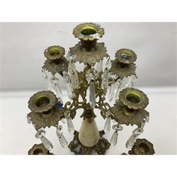French brass and marble four branch candelabra, the branches cast with ornate foliate scrolls with leafy nozzles and drip pans hung with prismatic drops raised upon tapering central marble column, together with two candlesticks, tallest H42cm