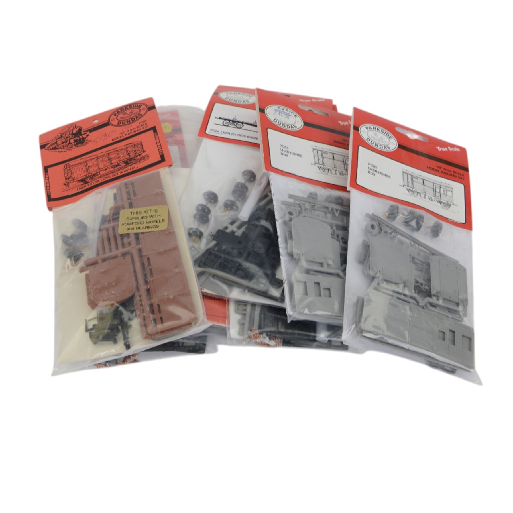 Twenty Parkside Dundas 00 gauge unbuilt model railway wagon kits, mostly LNER bogie bolster wagons and LNER horse boxes, all carded, together with a small collection of decals