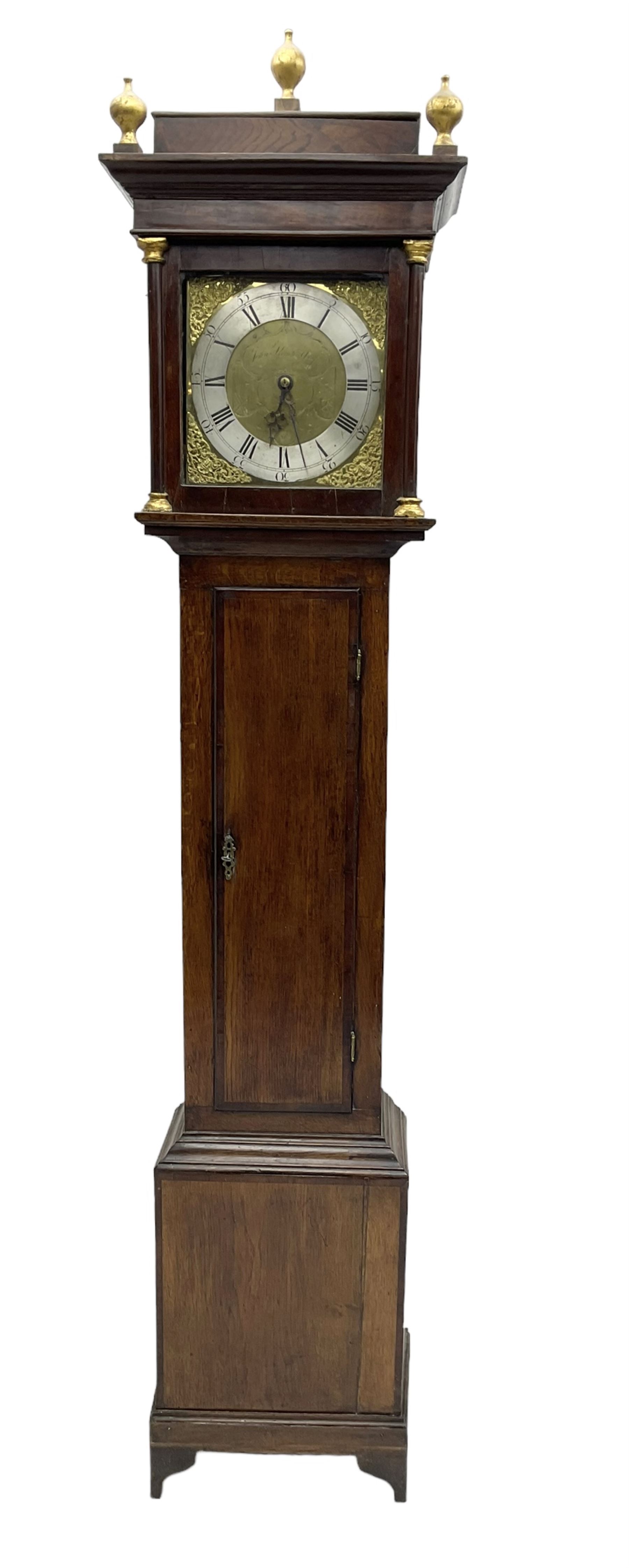 John Kemp of Yoxford (Suffolk) - 18th century oak 30 hour longcase clock c1770, with a later box top and finials, square hood door with attached pilasters and gesso capitals, long flat topped trunk door with a rectangular plinth and bracket feet, brass dial with cast spandrels and engraved dial centre, silvered chapter ring with Roman numerals and five minute Arabic's, with matching steel hands, birdcage chain driven movement with a recoil anchor escapement and count wheel striking. With weight and pendulum.
