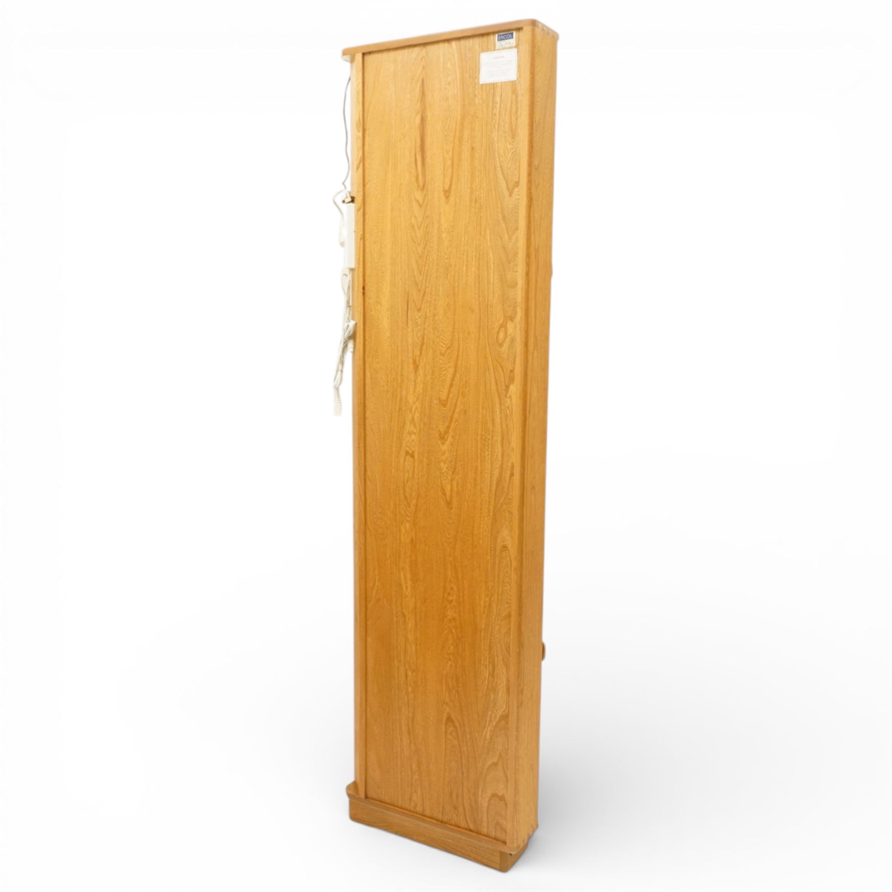 Ercol - elm corner display cabinet, Model 3856. Glazed upper section with glass door enclosing two glass shelves and interior light, above panel cupboard door, with rounded uprights and circular turned handles, on plinth base