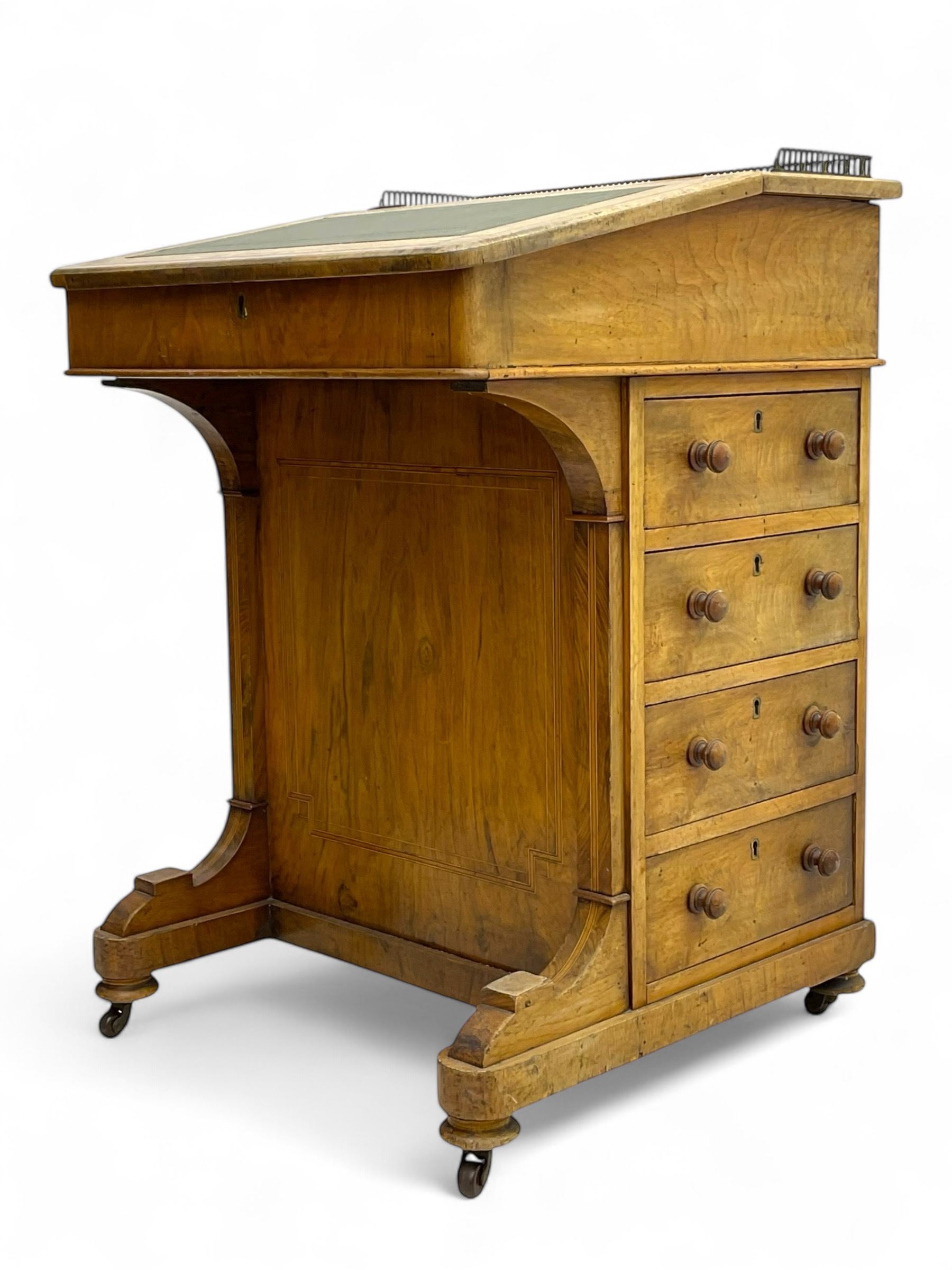 Early 19th century burr walnut Davenport desk, sloped leather-inset writing surface with brass gallery, fitted with an inkwell compartment and pen slot, four drawers to one side, raised on scrolled supports terminating in castors