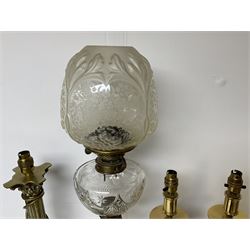 Oil lamp with frosted floral shade and cut glass reservoir, upon cast brass and marble base, together with a cast brass Corinthian column table lamp, pair of brass table lamps and a composite metal figure of a violinist 