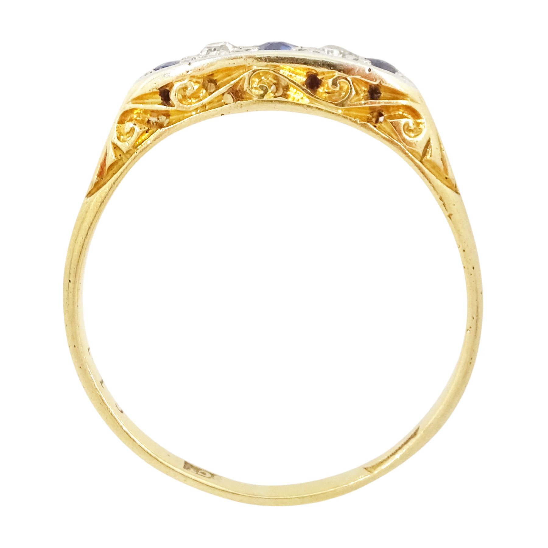 Early 20th century 18ct gold sapphire and diamond five stone ring, set with three round cut sapphires and two old cut diamonds and scroll engraved gallery 