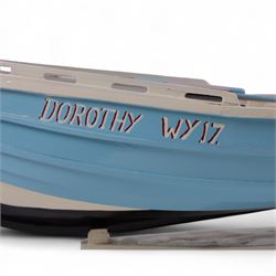 Wooden model of the Whitby fishing coble WY.17 G.Burdon 'Dorothy', painted in blue and white with red detail, with rudder and oars, on a painted wooden stand, L73cm, H20cm