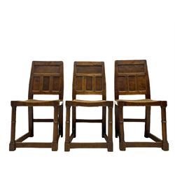 'Gnomeman' set of three oak dining chairs, panelled backs over curved seat rails with drop in rope rush seats, turned front supports with collar joined by plain stretchers, two with carved seated gnome figures, painted

Provenance - This collection of early 'Gnomeman' furniture comes to us directly from the Whittaker family. The pieces were made by the vendor's father Thomas Whittaker in the 1930/40s for his own use. During this time, he lived in York and made items for himself and friends. Whittaker adopted the gnome as a signature and trademark after his move to Littlebeck, Whitby.
