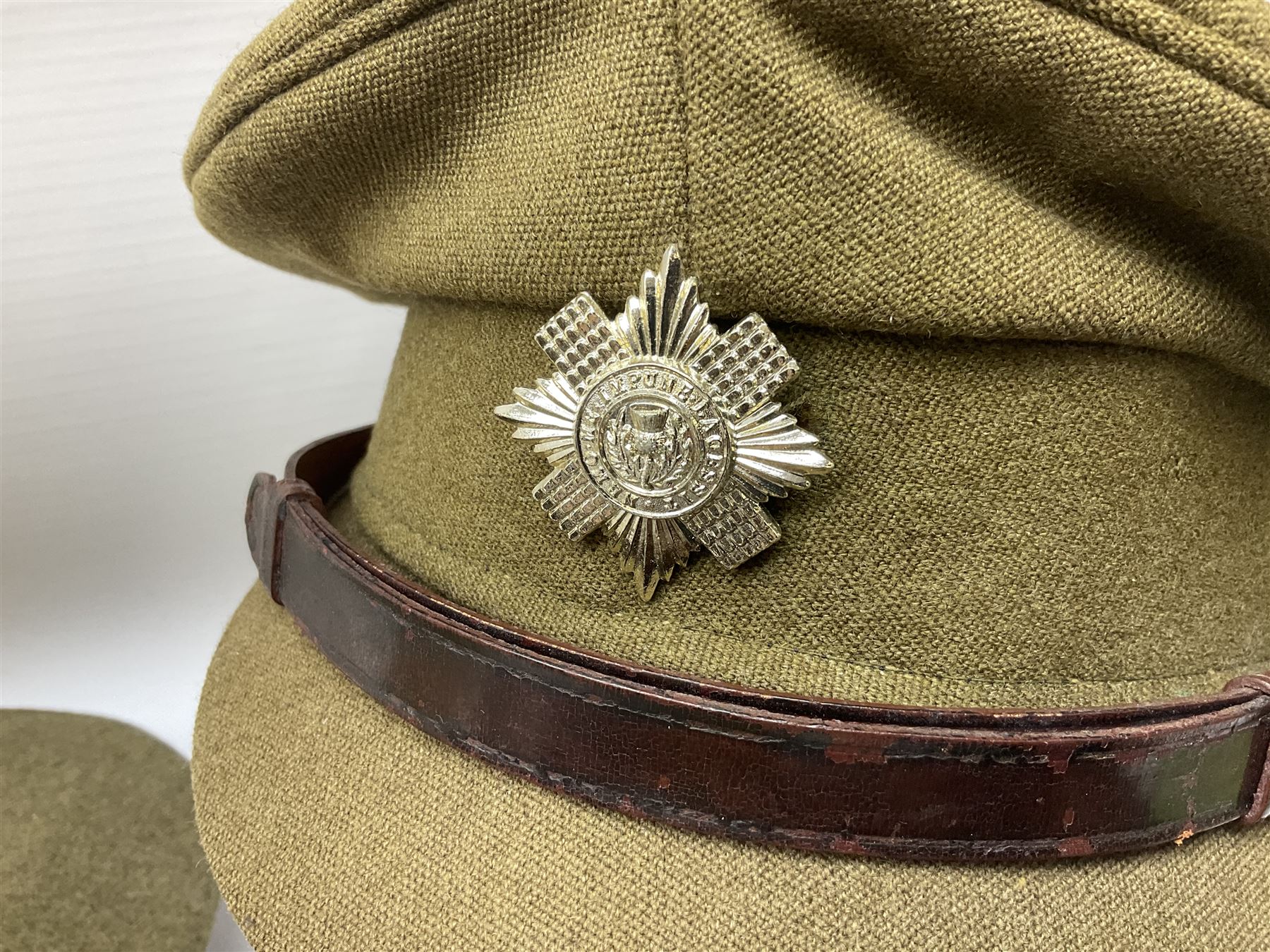 Early 20th century British army peaked cap with Scots Guards brass badge; another later with Scots Guards Staybrite badge; modern pith helmet; British army water bottle with later webbing cover; pair of Carl Zeiss blc 7 x 50 binoculars; and Dunn & Co bowler hat