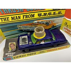 Corgi Toys - 'The Man from UNCLE' Thrushbuster No.497, in blue with cast hubs, plastic lights, complete with plastic figures, inner pictorial stand with circular cardboard packing piece, yellow card protective packing disc and '3-D Waverley Ring'; boxed