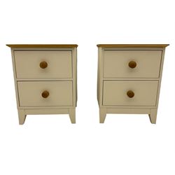 Pair of cream finish bedside lamp chests, fitted with two drawers, oak top and handles