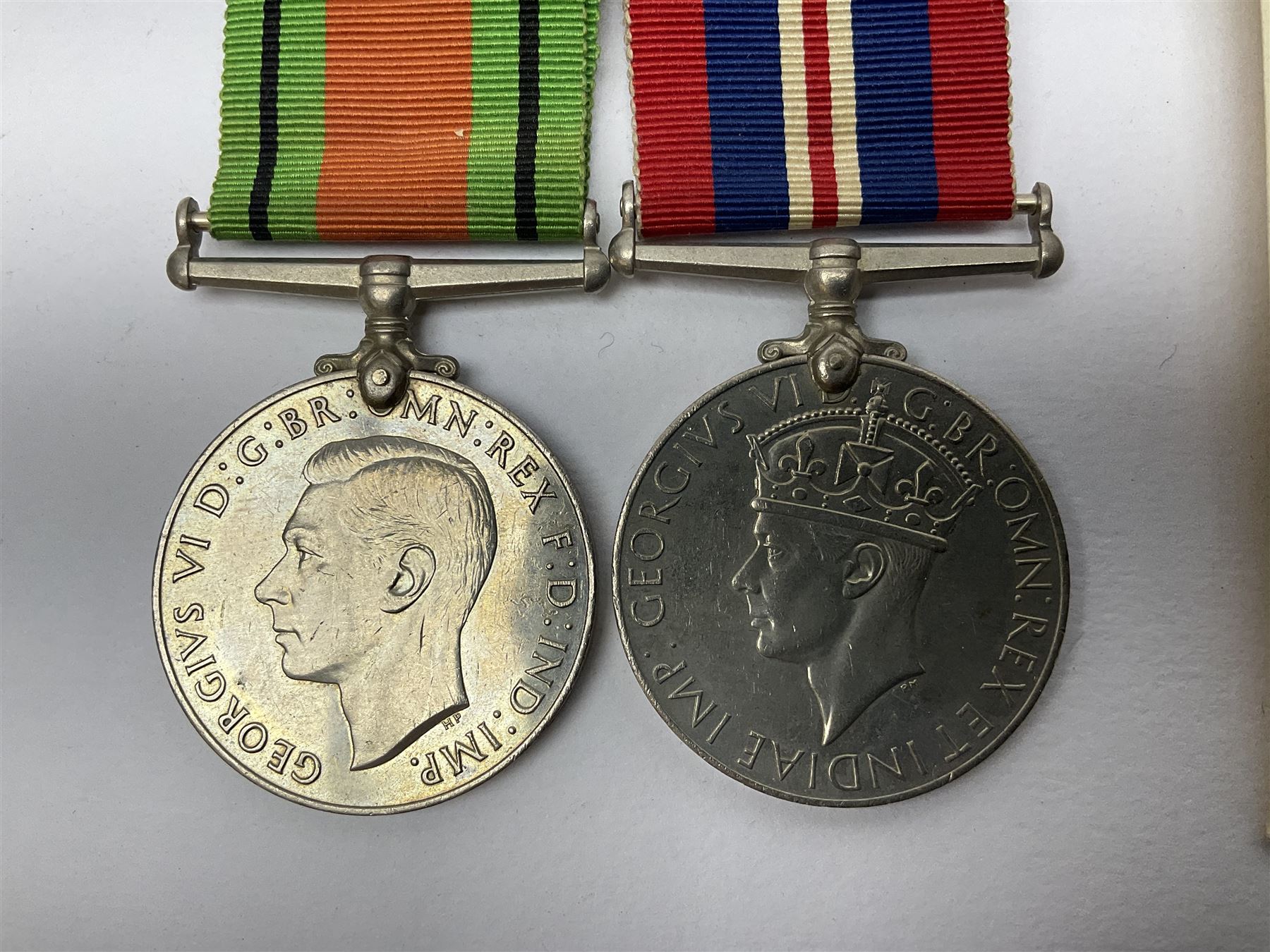 Twelve WW2 medals comprising four 1939-1945 war medals, four Defence medals, three 1939-1945 Stars and Africa Star; all with ribbons; some as groups in two issue boxes with slips