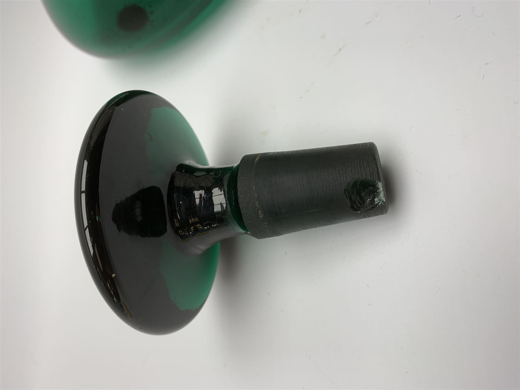 19th century green glass ships decanter with flat topped stopper, H21.5cm, together with a set of four 19th century green glass wine glasses, the funnel bowls upon bladed knopped stems and circular feet, H13cm