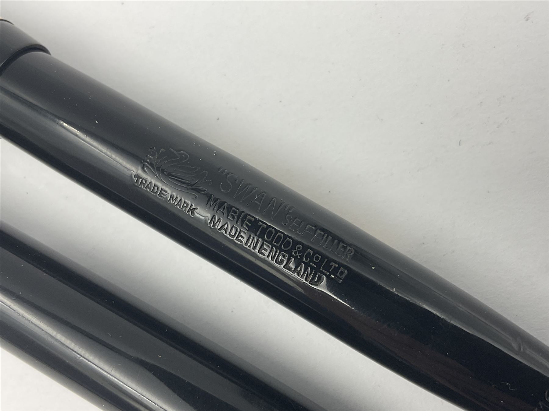 Three Swan Mabie Todd fountain pens, comprising Self Filler 3162 with black barrel and cap with single band and gold nib stamped Eternal 1 14ct, together with two Calligraph examples with gold nibs stamped 14ct, one with box, largest L12.5cm