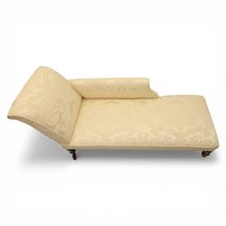 Victorian chaise longue upholstered in ivory damask fabric, padded back and armrest with rope piping, raised on turned feet with castors