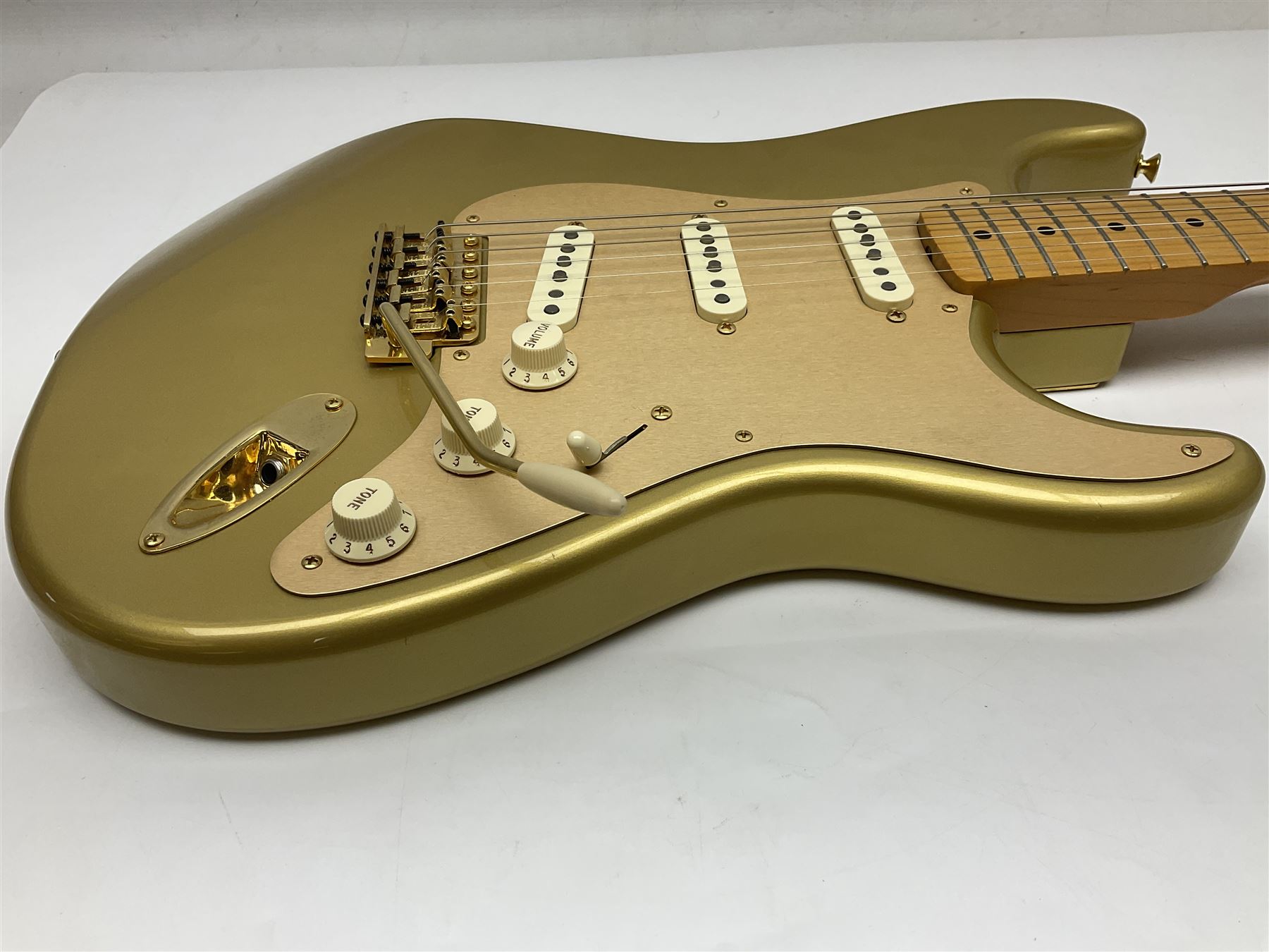 Fender Stratocaster 50th Anniversary 2004 metallic gold electric guitar; serial no.MZ4116369; L98cm; in Spider fitted case with owners manual and other paperwork, strap and belt buckle etc