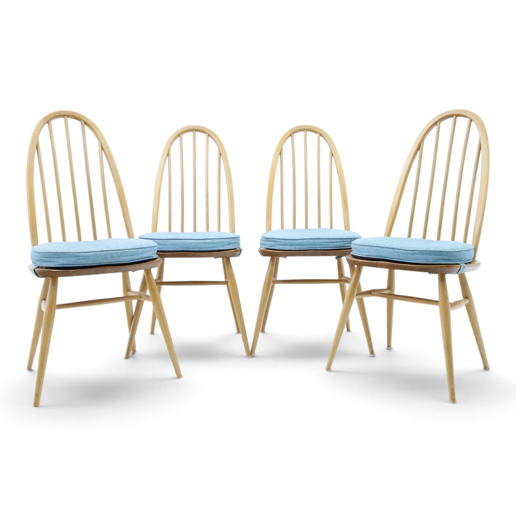 Ercol - set of four 'Quaker' dining chairs, with high hooped back, blue seat cushions with studded, tapered supports  