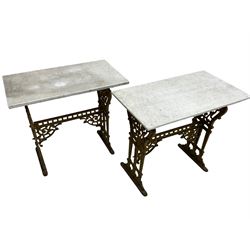 Pair of 19th century cast iron entrance tables, rectangular marble top over ornate gilt bases with scrolling foliate design and sledge feet, united by balustrade stretcher with scroll spandrels