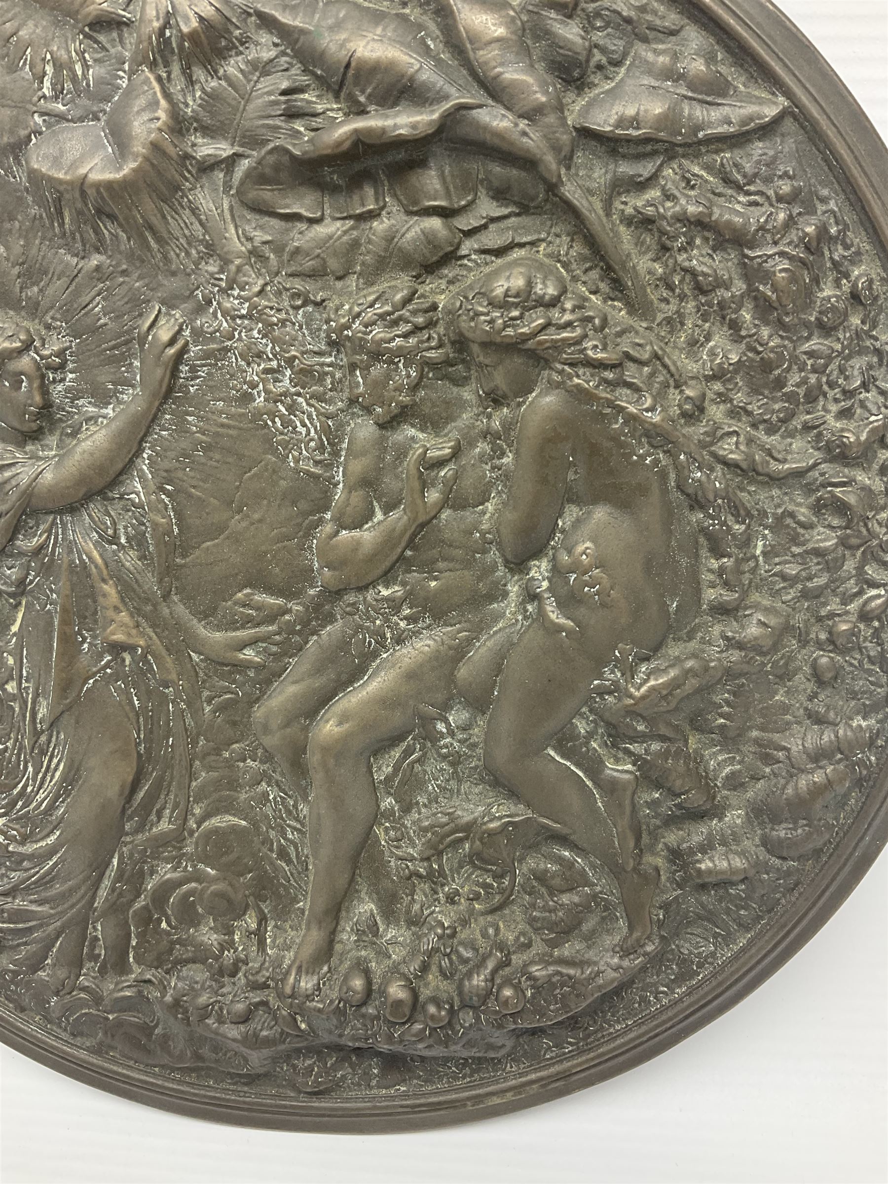 Late 19th century bronze plaque, of circular form, depicting the angel appearing to Adam and Eve in the garden of Eden in high relief, D25.5cm
