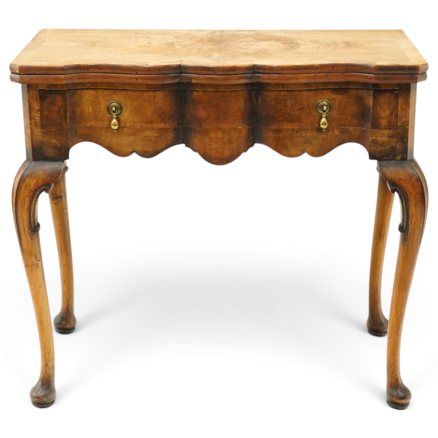 Quality early 20th century Queen Anne design walnut card table, rectangular book-matched veneer fold-over and swivel top with scalloped edge enclosing baize-lined interior, fitted with shaped frieze drawer with brass pear-drop handles over shaped apron, raised on C-scroll carved cabriole supports with pad feet