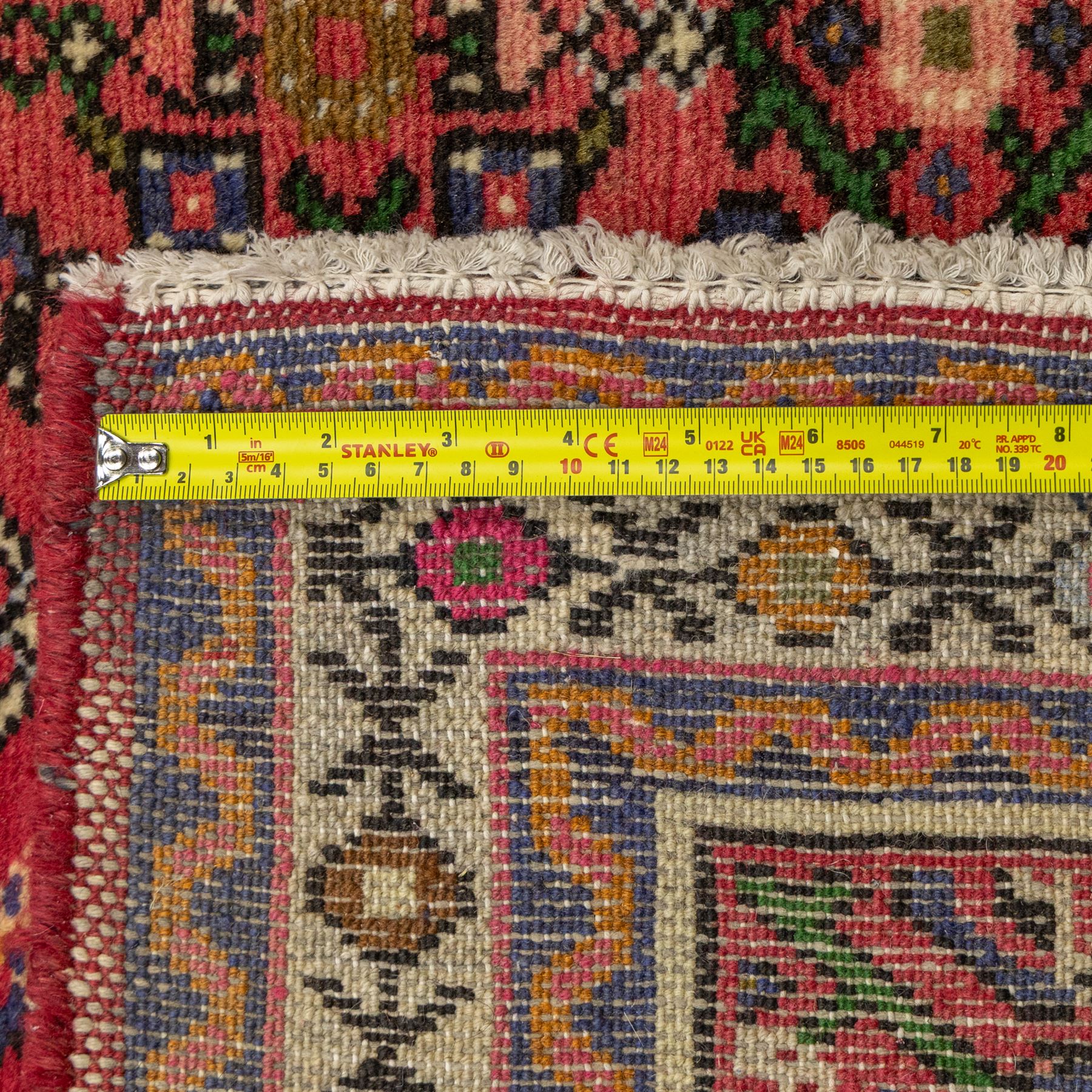 North West Persian runner, red field decorated with repeating herati motifs and small flowerheads, enclosed by cream main border with stylised floral motifs and narrow guard borders, fringed ends