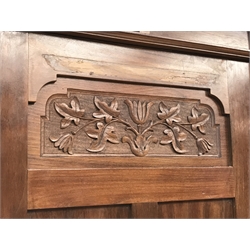 Irish Arts & Crafts walnut triple wardrobe circa 1908, projecting cornice above three doors enclosing fitted interior, single full length bevel edge mirror, platform base, W173cm, H204cm, D56cm