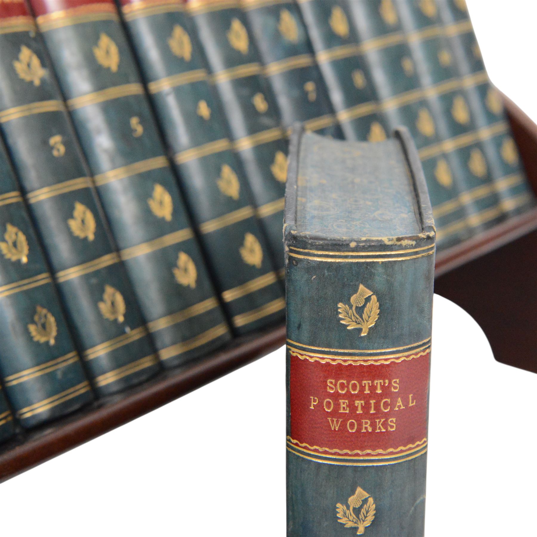 Edwardian book trough, the serpentine ends with boxwood stringing, pierced foliate keyhole shaped detail, and integrated shaped supports, housing Scott, Sir Walter, Poetical Works, Edinburgh, 1868, 12 vols, book trough 18.5cm x 38cm x 22.5cm
