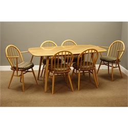  Ercol 'Windsor' light finish elm and beech dining table, rectangular top on tapered supports (152cm x 84cm). and set six (4+2) Ercol stick and hoop back dining chairs with original seat cushions   