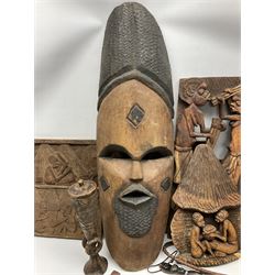 Quantity of carved African art, to include spirit mask, carved wall plaques, spears, horse air fly whisk etc 
