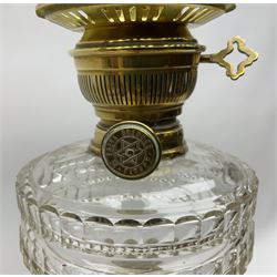 Victorian brass oil lamp, the square stepped base leading to a Corinthian column supporting a part slice cut clear glass reservoir, burner, clear glass chimney and foliate etched glass shade with amber rim, overall H80cm