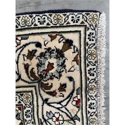 Persian Kashan rug, ivory ground with trailing and interlacing foliate design and decorated with stylised flower heads, repeating guarded border with scrolling decoration 