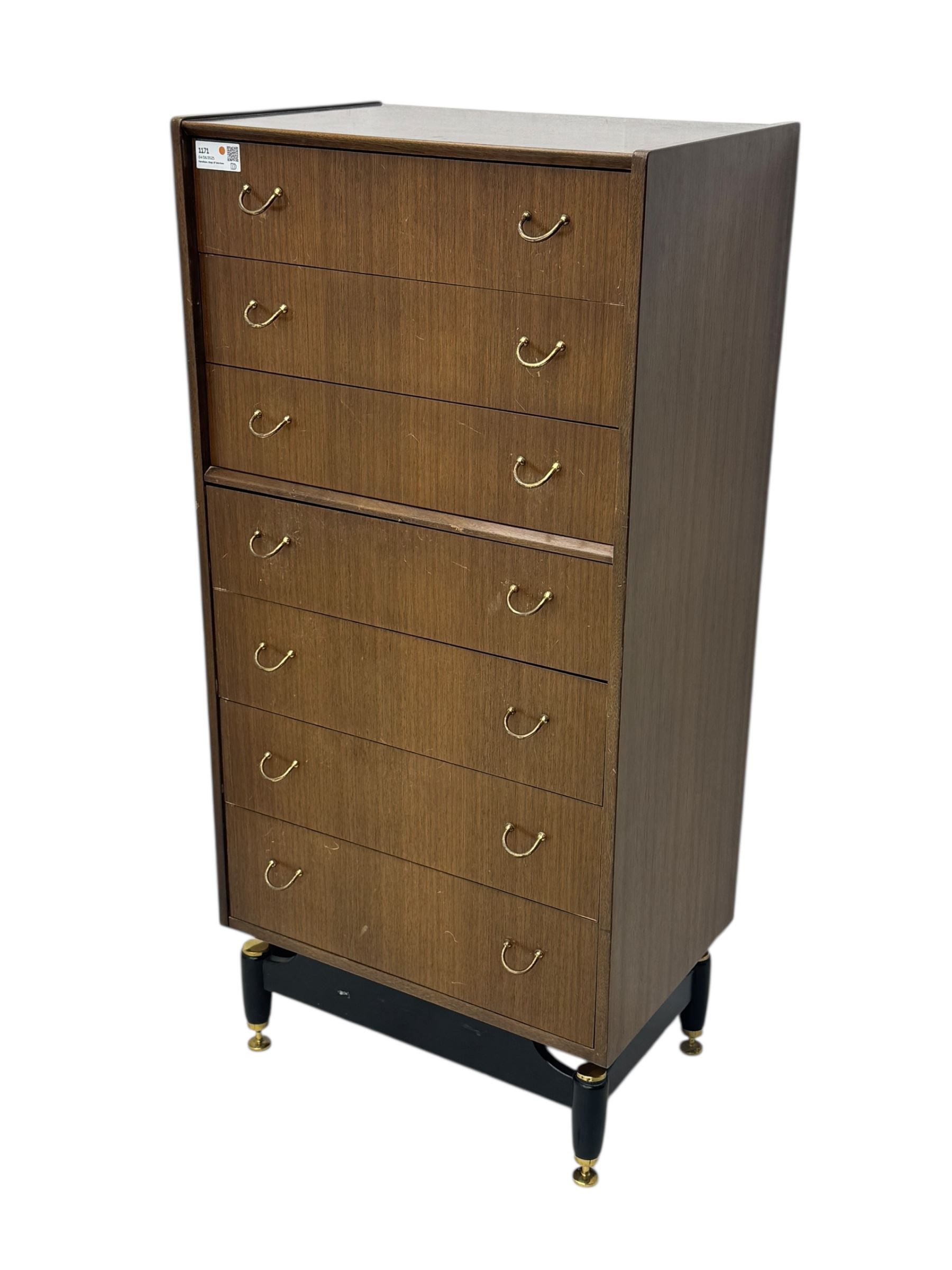 G-Plan teak tallboy, seven drawer chest with brass loop handles, ebonise base with adjustable brass terminals