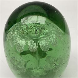 Two Victorian green glass dump paperweights with interior flower decoration, largest H14cm