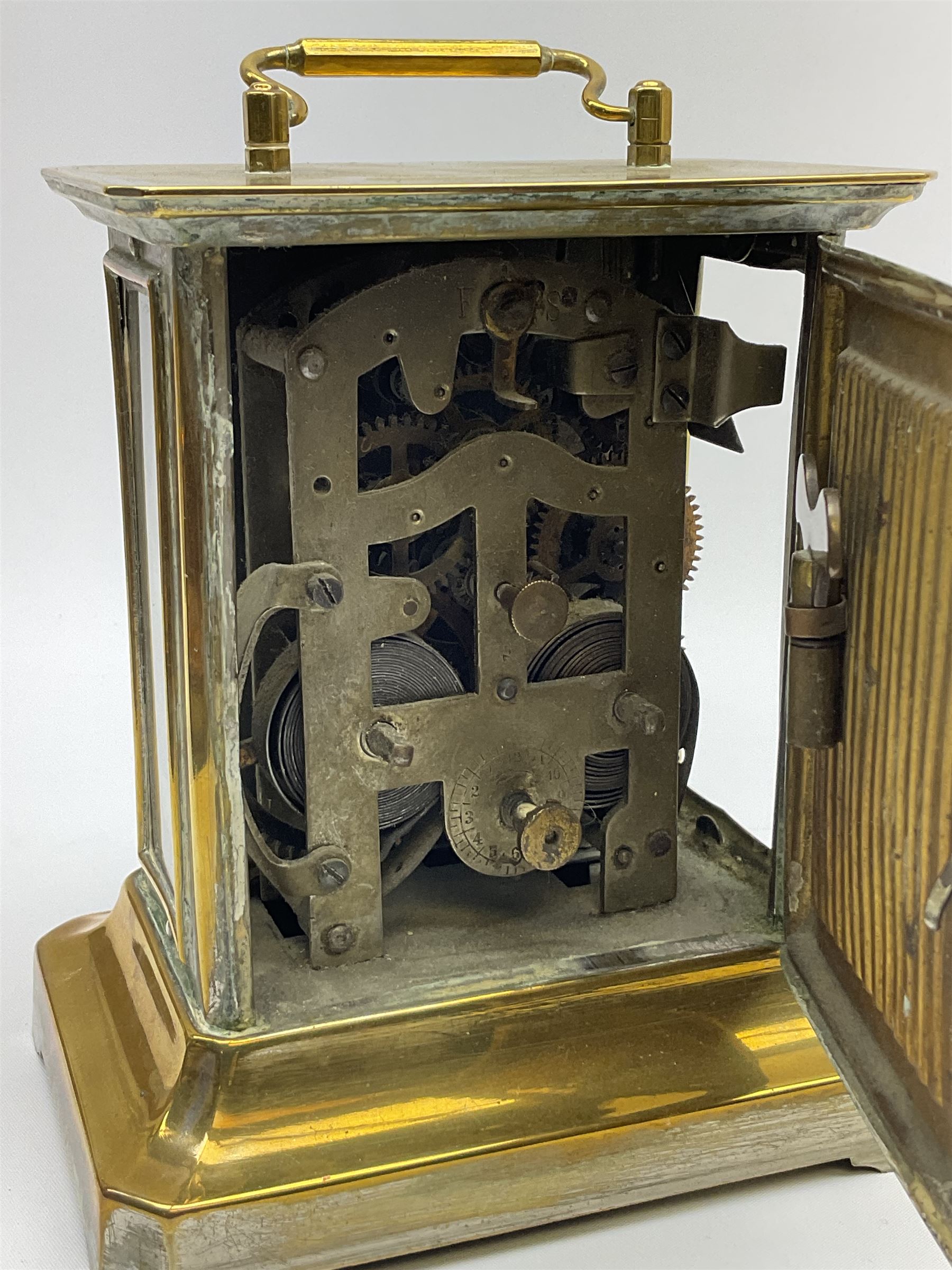 Late 19th century German Junghans “Joker “carriage clock with a musical alarm, engraved rectangular dial plate, circular card dial within an integral glazed bezel, roman numerals, minute track and alarm dial, steel spade hands, glass side panels (one missing) and rear case door, thirty-hour spring driven movement, pin pallet balance escapement, rear wound and set. 
With key.
