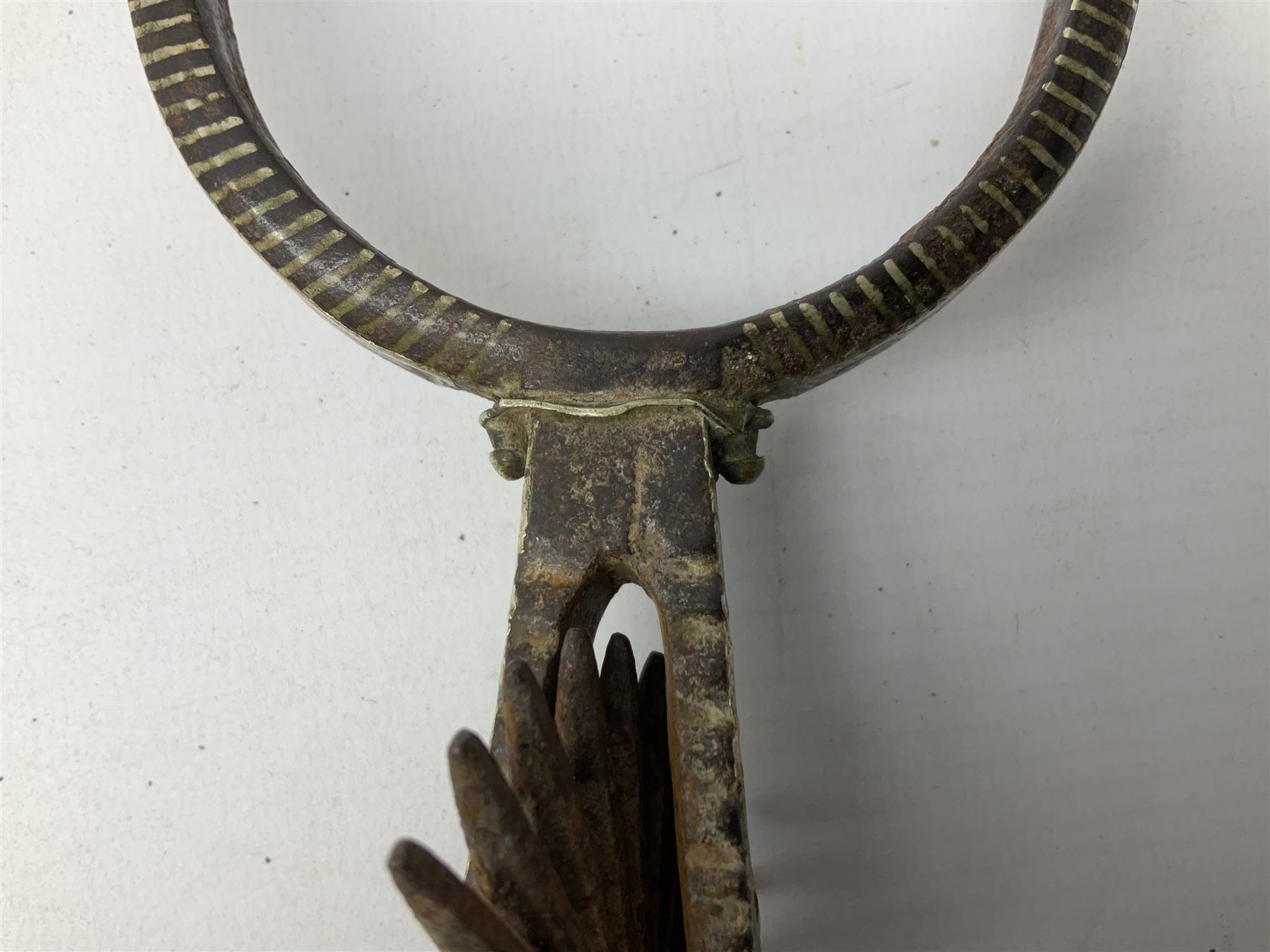 Pair of late 19th century South American iron spurs, engraved silver mounts, with sunburst rowls