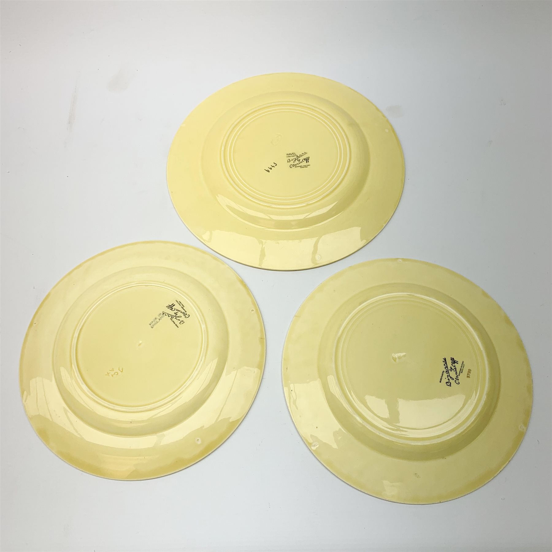 A Clarice Cliff Bizarre by Wilkinson/Newport Pottery vegetable tureen and cover, dinner plate and two dessert plates in the Ravel pattern. (4).