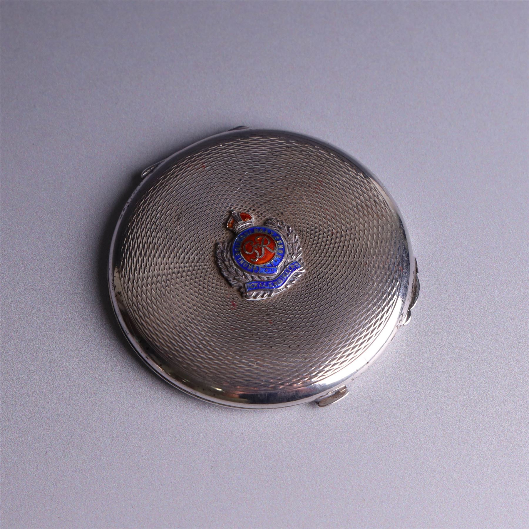 1930s silver cigarette case, of curved rectangular form with engine turned decoration and vacant cartouche, hallmarked Joseph Gloster Ltd, Birmingham 1934 and a 1930s silver sweetheart compact with engine turned decoration and enamel Royal Engineers crest, hallmarked Crisford & Norris Ltd, Birmingham 1939, cigarette box L12cm, H8cm