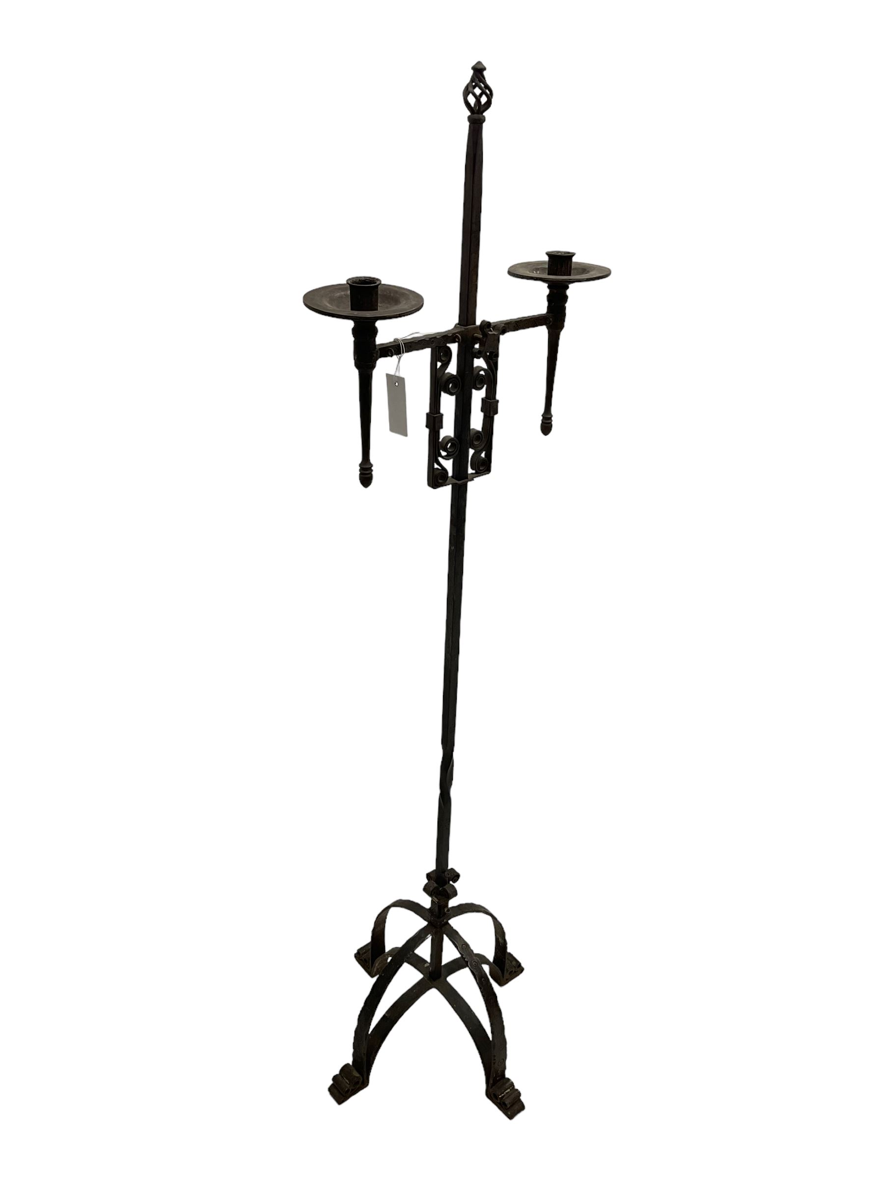 Ironwork candle holder stand, with stamped decoration, adjustable two branch sconces with scrolled iron work, twist stem with arched supports with scrolled terminals