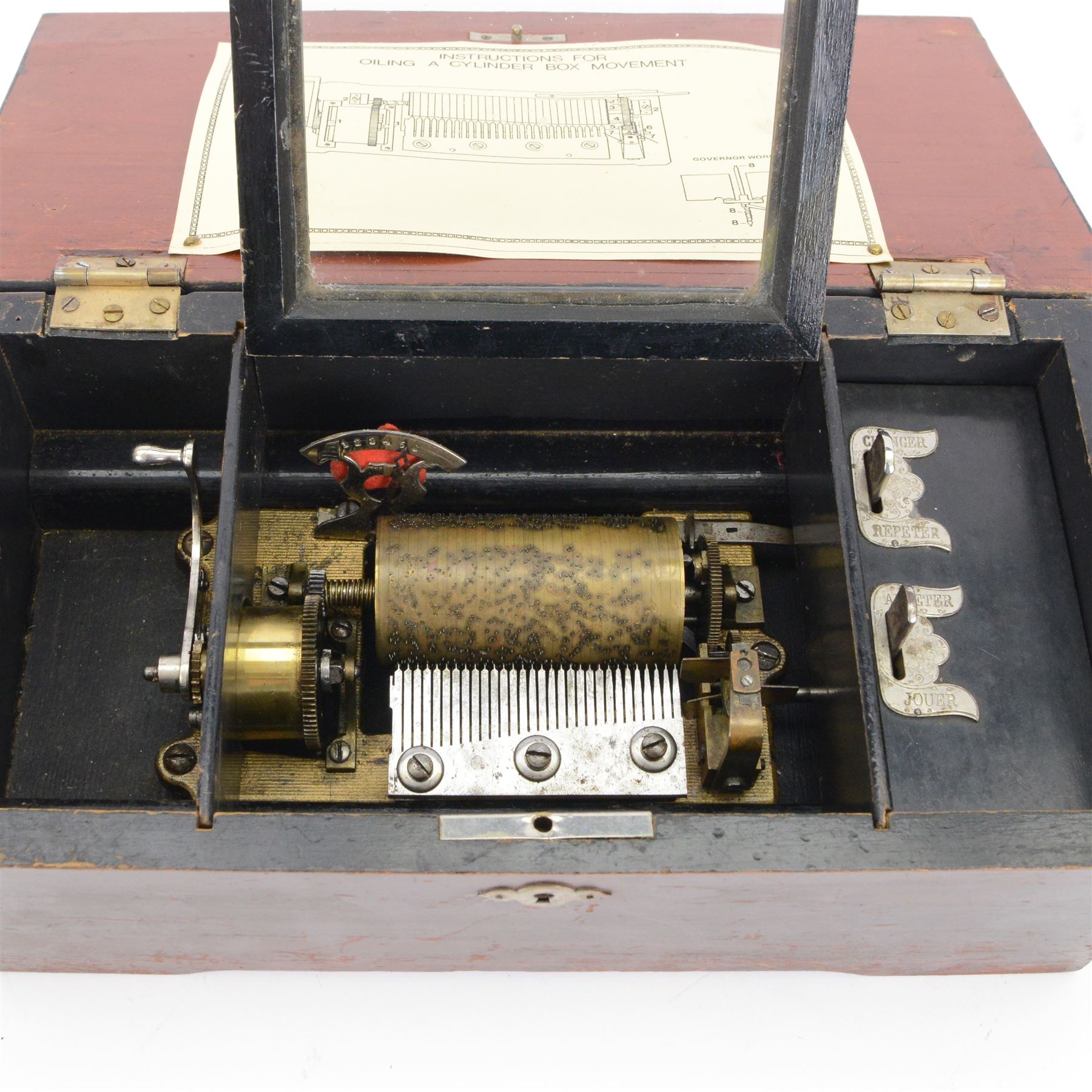 Early 20th century Swiss musical box- in a plain mahogany finished case playing six airs on a 30 tooth steel comb, with a 3-1/4”  pinned cylinder and tune indicator, with play/stop/repeat/change/ levers, crank wound spring driven barrel with Geneva stopwork, case fitted with an internal viewing glass.