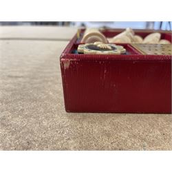 19th century walnut and brass bound games compendium box, painted to enhance the grain, of rectangular form, the hinged opening cover with rounded sides, central brass cartouche with engraved lion crest, and brass riveted straps, opening to reveal a red leather and blue silk lined compartmented interior, with fold-down games board, and lift-out tray containing playing cards, ebony turned dice towers, white and red stained bone draughts, and chess pieces, ivory dice, and ivory and ebony whist markers, and brass bezique board, cribbage board and markers, H15cm W32cm D24cm
This lot has been registered for sale under Section 10 of the APHA Ivory Act