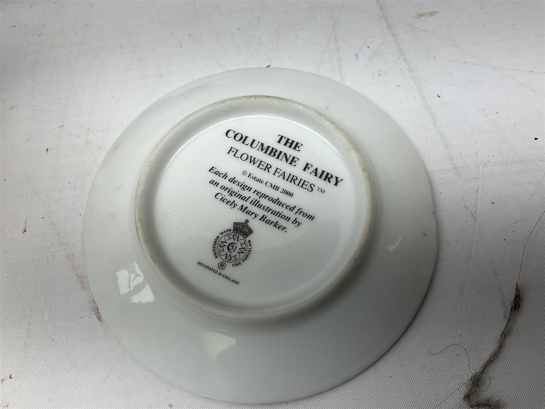 Royal Worcester Flower Fairies oval collectors plates, Goebel mustard pot, two Danbury Mint Fairy Tale bells, and pair of Hutschenreuther candlesticks decorated with scenes of Puss in Boots