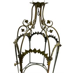 19th century brass and clear glass hexagonal hall lantern, with scrolling wire work open domed top over six arched panels, including a hinged door, the base enclosed with a circular glass panel on turned feet, H64cm
