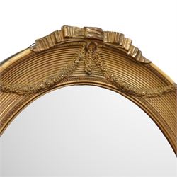Edwardian neoclassical style oval giltwood mirror, ribbed frame, decorated with floral wreaths and ribbons 68x57cm