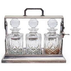 Mappin & Webb silver plated tantalus, with three square glass decanters each with silver plate collars, complete with key, H29cm