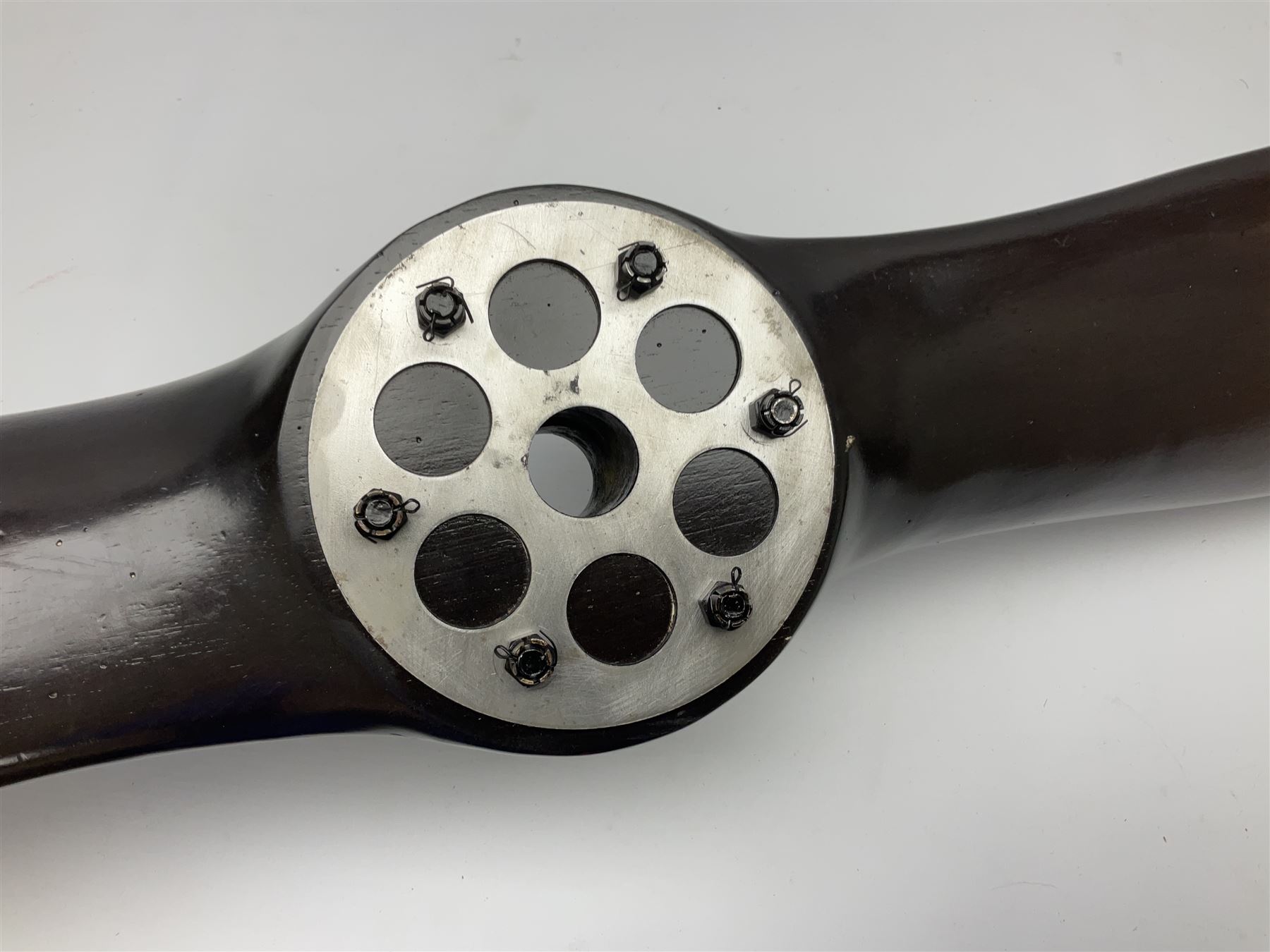 British World War II era laminated wooden four-bladed generator propeller, late 1930s-40s, used to power a drogue winch used by a target tug aircraft; marked with DRG drawing number T29505-2-4 N760 on the hub and impressed circle mark 'P.M.P.W. 1'; light weight four plank mahogany laminate with 9.5cm diameter metal plates mounted to front and rear faces of hub for 15mm shaft; one plate marked T29504-2/198 D91cm; together with a modern reproduction brass edged mahogany two-blade propellor L