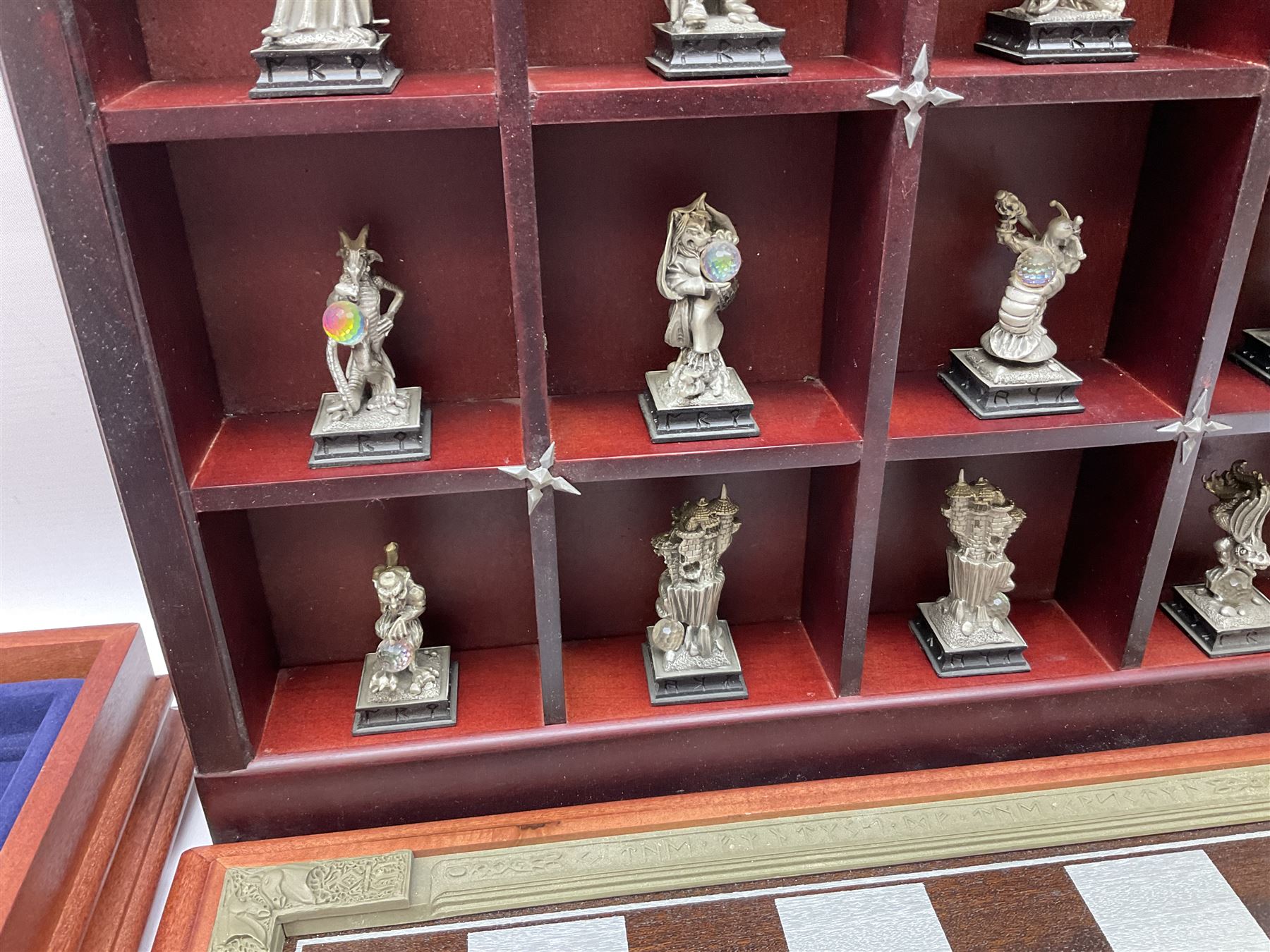 Danbury Mint 'The Fantasy of the Crystal' chess set consisting of mythical pewter chess pieces within a wooden case with chess board lid, together with 16 additional chess pieces in a wooden display case.