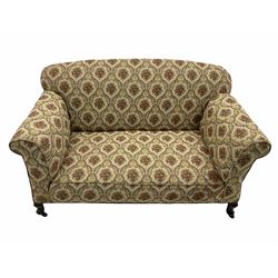 Early 20th century two seat drop arm sofa, and pair of matching armchairs, upholstered in beige patterned fabric