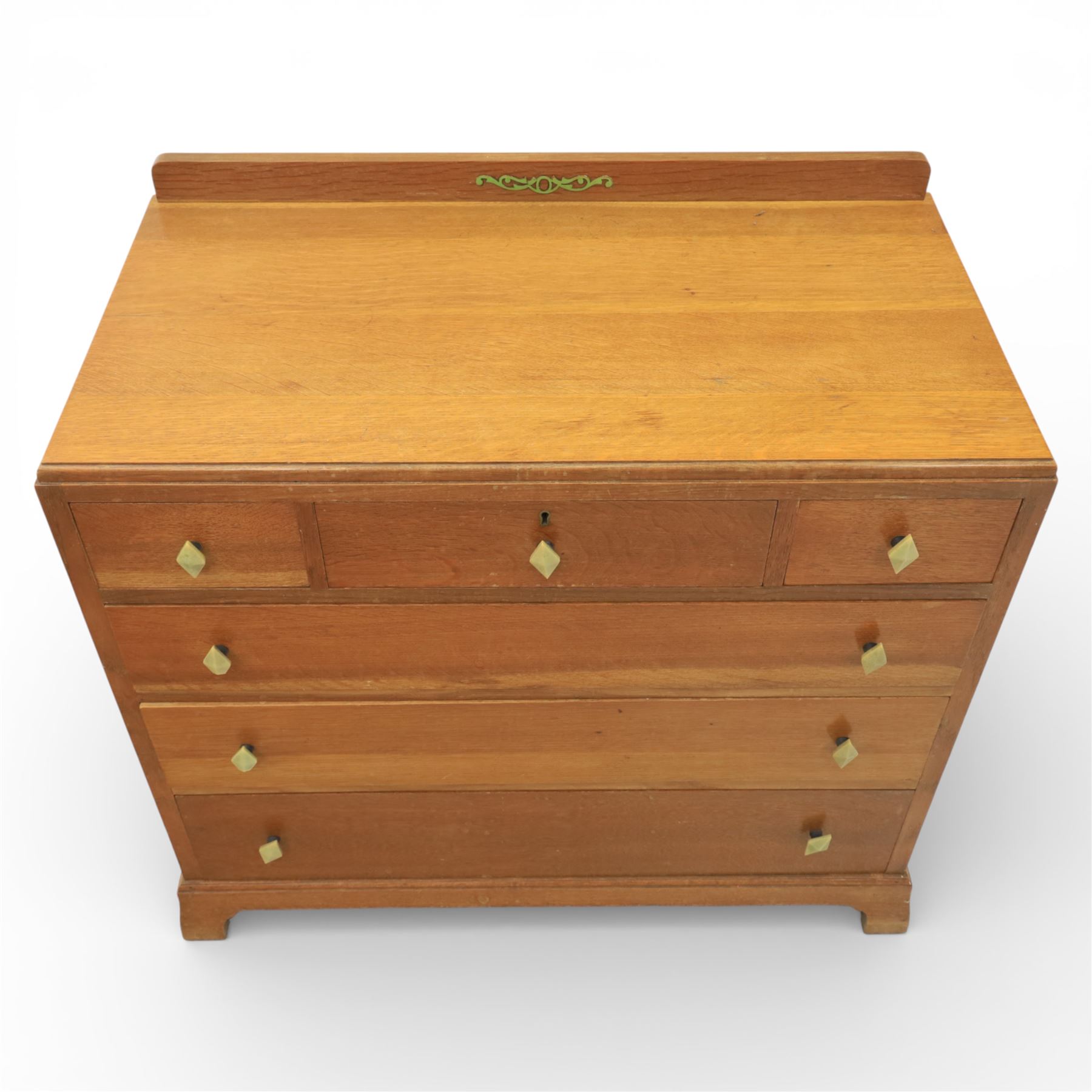 Early 20th century Art Deco bedroom suite, comprising double wardrobe, dressing table and chest of drawers, constructed in walnut with figured veneers and geometric banding, the wardrobe with arched top and panelled doors enclosing a fitted interior, the dressing table with rectangular top below a three panel mirror arrangement, fitted with two short over two long drawers, the chest with three short and three long drawers, each piece fitted with faceted handles and raised on shaped feet
Wardrobe (H 177cm, D 46cm, W 112cm)
Chest (H 85cm, D 48cm, W 92cm)
Dressing table (H 160cm, D 52cm, W 106cm)
