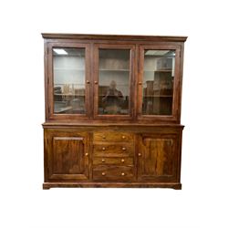 Large hardwood display wall unit, the upper section fitted with three glazed doors enclosing six shelves, the lower section fitted with four central drawers flanked by two panelled cupboards