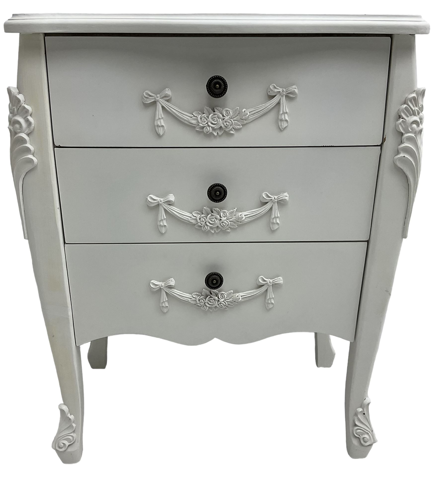 French design white painted chest, shaped top over three drawers, each with applied swags with flower heads, flanked by cabriole uprights with foliate mouldings