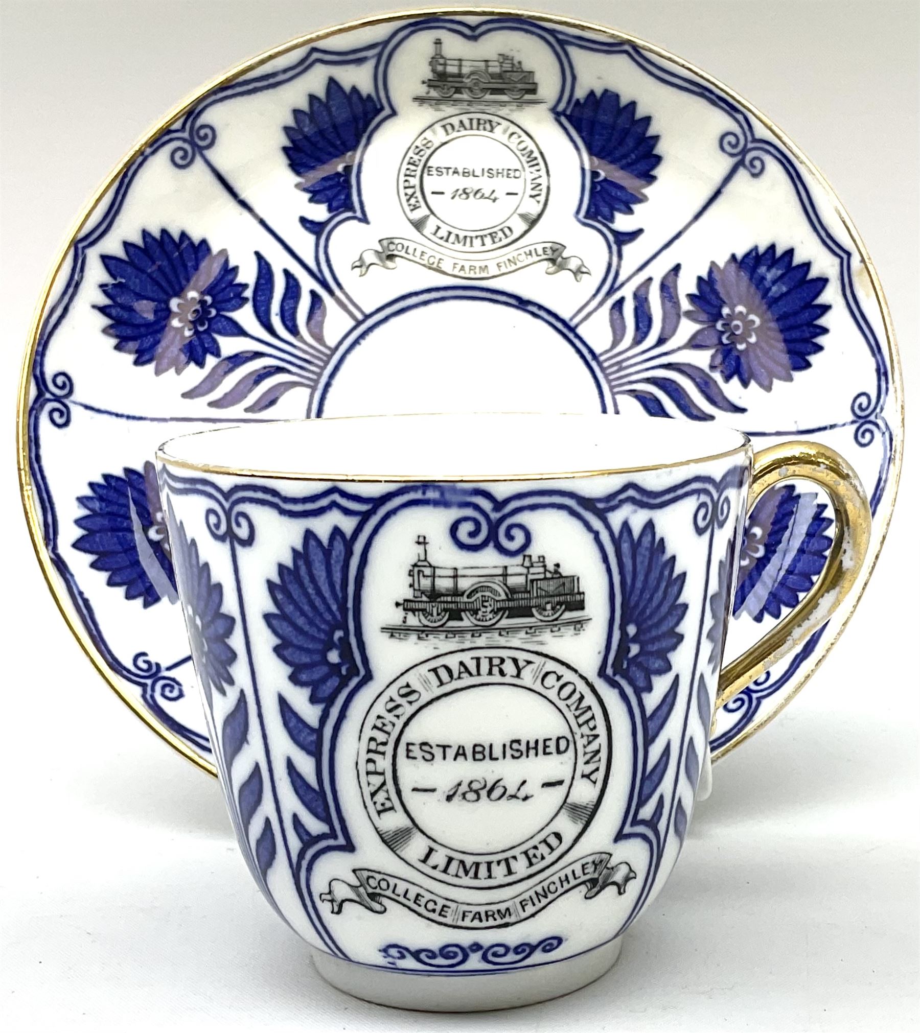 Late 19th century Coalport porcelain cup and saucer in the 'Aster' pattern bearing the crest of Express Dairy Company Limited, College Farm, Finchley and decorated with a steam locomotive