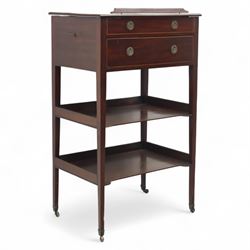 George III mahogany and boxwood-strung drawing table, the rectangular sloping reading surface with rest and oak stay, above a blind drawer and a drawer fitted with brass ring handles, side with pull-out candleholder and inkwell compartment, raised on square-section tapered legs with brass box castors united by two galleried under tiers